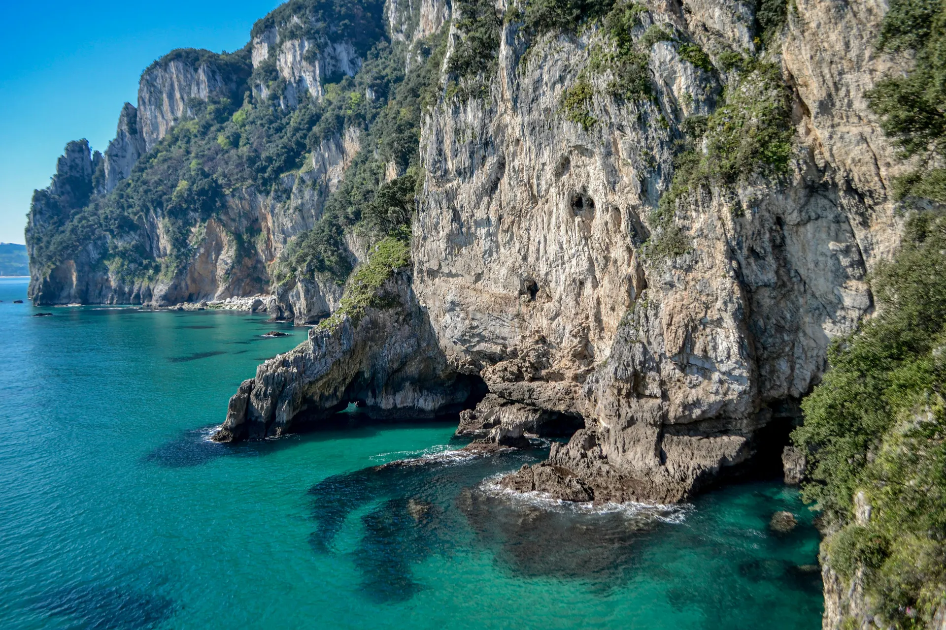 Tropical island coastal trail with limestone cliffs and turquoise water